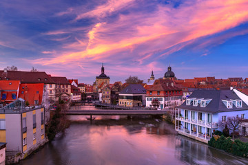 Obraz premium Aerial panoramic view of Old town hall or Altes Rathaus with bridges over the Regnitz river at sunset in Bamberg, Bavaria, Upper Franconia, Germany