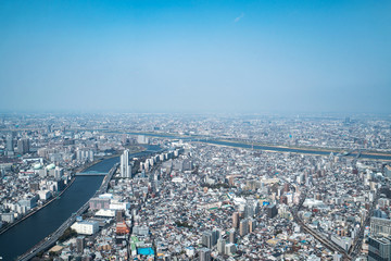 Naklejka premium Tokyo, Japan - Mar 27, 2019:Asia business concept for real estate and corporate construction - panoramic urban city skyline aerial view under sky in tokyo, Japan