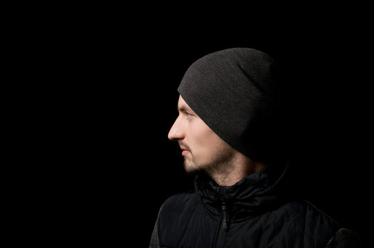 young man in a hat on a black background
