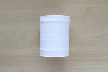 Roll of toilet paper or tissue on wooden background