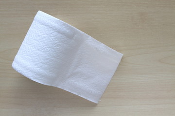 Roll of toilet paper or tissue on wooden background