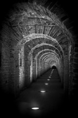 Brick tunnel archway made of red bricks as a passage between the two wings of a medieval castle....