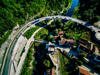 Aerial view of bridge over Korana river canyon and traditional village Croatia