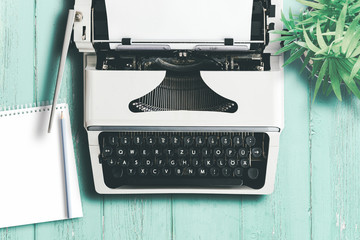 top view of old typewriter on colorful wooden table, writing and content creation concept