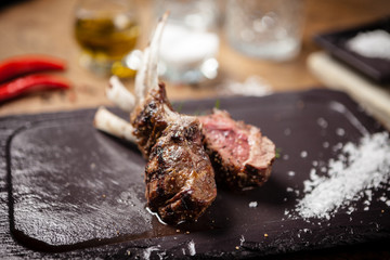 Grilled lamb chops served with a branch of rosemary
