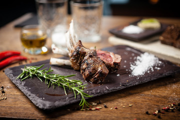 Grilled lamb chops served with a branch of rosemary