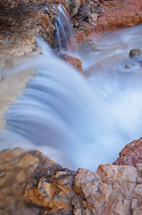 Fototapeta premium Landscape of a waterfall captured with motion blur, Mossy Cave section of Bryce Canyon National Park, Utah, USA