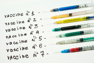 Many multi-colored syringes with various vaccines. The concept of choosing an effective vaccine.