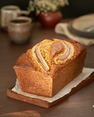 Banana bread. Cake with banana, traditional american cuisine. Whole loaf. Side view, close up.
