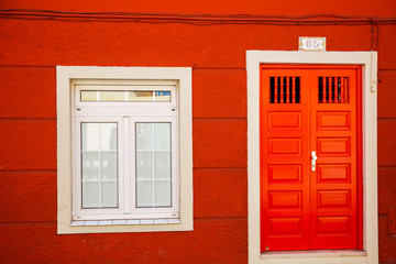 red background with wooden window
