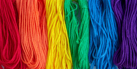Sewing threads as a multicolored background close up