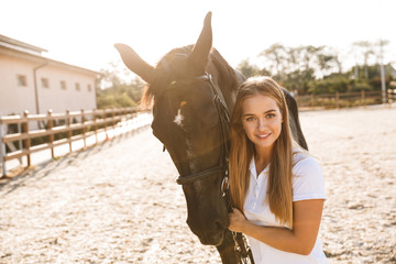 Beautiful woman with horse in countryside