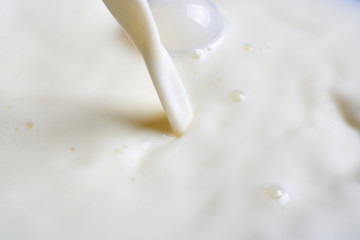 Pouring milk or white liquid.