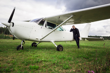 Portrait of a man with an airplane on the runway