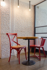 Red chairs and wooden table in coffee shop