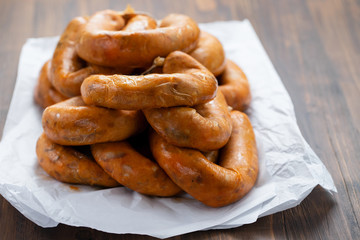 portuguese smoked sausages alheira on paper wooden background