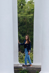 girl between the columns in the park
