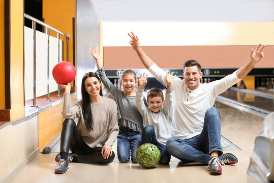 Happy Family Spending Time Together In Bowling Club