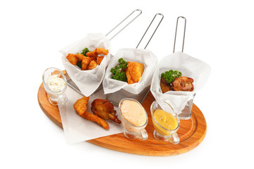 Beer snacks set close up. Grilled cheese, nuggets, chicken wings and sauces isolated on white background.