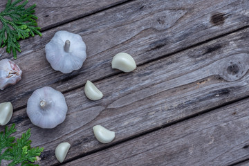 Top view of herbal vegetable ingredients, fresh garlic and red onion, on old wooden table, cooking preparation concept