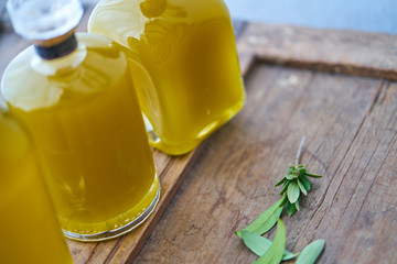 closeup of bottles with  fresh yellow  golden oil or  juice in sunny summer atmospher in country...