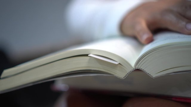 Reading textbook for education learning or hobby leisure time concept : People opening law book for cognitive knowledge and study searching information for test exam in library.