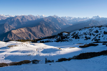 Fototapeta na wymiar Amazing view of snow clad mountain landscape during Kedarkantha winter trek in Uttarkashi, Uttarakhand (India). Trek in December on Christmas and New Year