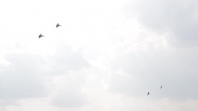 Four fighter jets in the blue sky. A general plan. Aerobatic figures. Airshow. 11 seconds