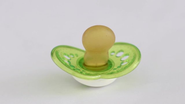 A  baby's pacifier swinging