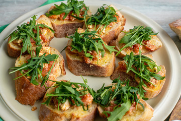 bruscetta with tomatoes, mozzarella and arugula