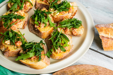 bruscetta with tomatoes, mozzarella and arugula
