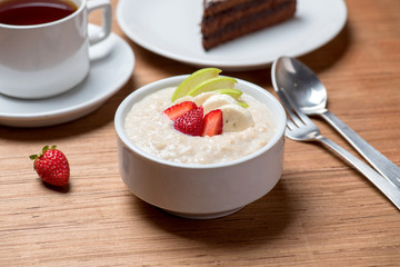 Healthy breakfast. Oat porrigge with strawberry, banana and apple