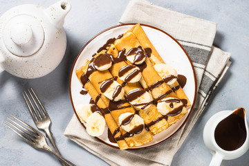 Crepes with chocolate and banana top view.