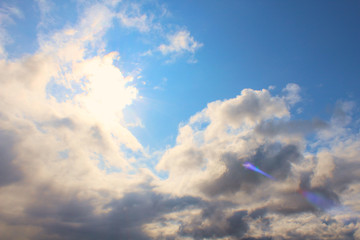 Rain clouds and bright blinding sun. Background. Scenery.