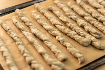 Crispy rye sticks sprinkled with flour. Rustic, laid out on a baking sheet.