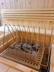 Heated stones in finish sauna, metal grate