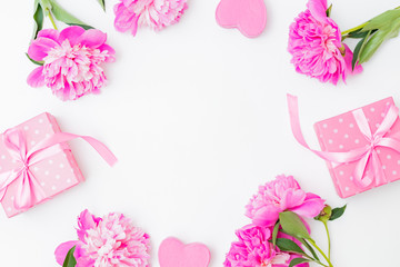 Flat lay valentines day frame with pink peonies and gift box on a white  background