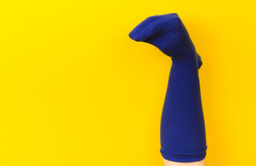 funny doll sock on yelow background, hand theater - Image