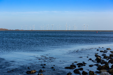 Windmills on a dyke for electric energy in Bruinisse the Netherlands