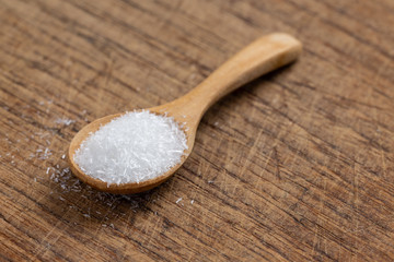 monosodium glutamate, MSG on wooden spoon