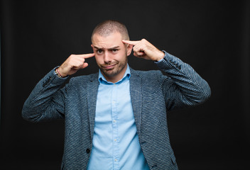young businessman with a serious and concentrated look, brainstorming and thinking about a...