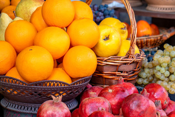 Street side shop selling fruits pomegranates, oranges, grapes and others.
