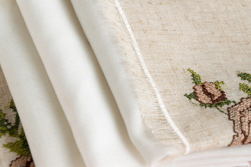 Close up view of the linen napkin with embroidery, piece of vintage calico