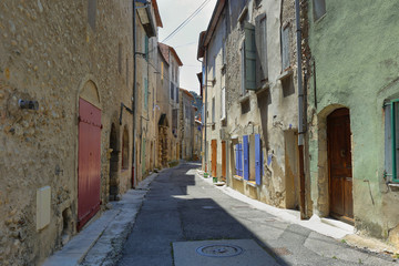 Deserted colorful medieval street in Les Mees village, Provence, France