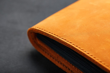 The album cover is made of brown genuine leather, handmade on a black background.