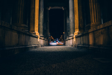 dramatic dark path through ancient columns in munich