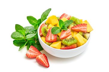 Fruit fresh salad in bowl. Healthy organic salad of mixed fruits strawberry, kiwi, mango, pineapple isolated on white. Diet, vitamin food. Tasty and health vegetarian meal, homemade salads concept