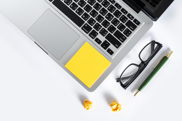 Isolated computer desktop with glasses  pen and notepad on white background