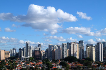 Flat cityscape with blue sky, white clouds and sun. Modern city skyline flat panoramic background....