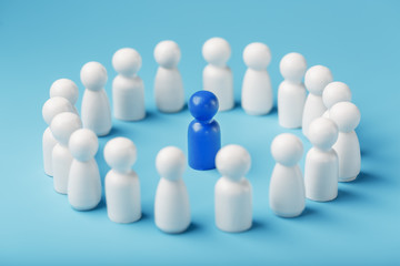 A team of white people stands around and listens to the leader's blue leader. The concept of the leader of the business team.